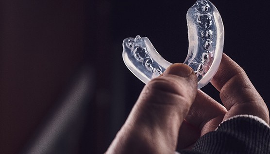 Patient holding clear mouthguard