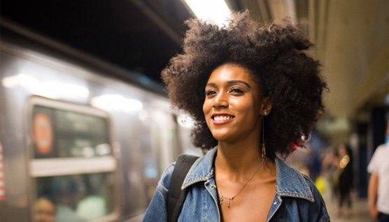 smiling person on a Metro platform