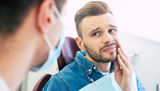 Man visiting orthodontist for orthodontic emergency in Queens