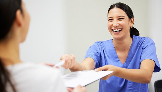a patient being handed an insurance form