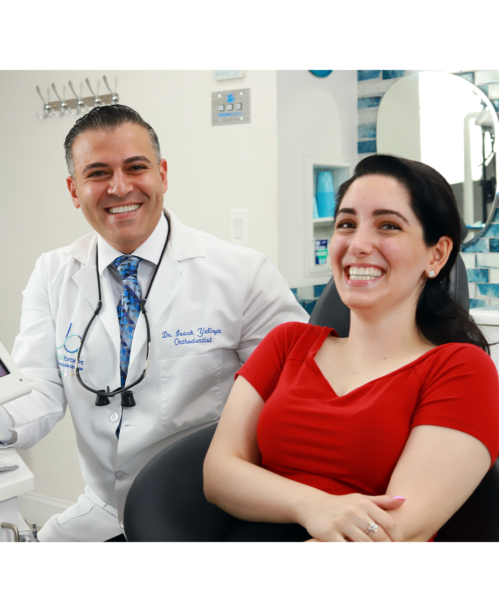Orthodontist and patient laughing together