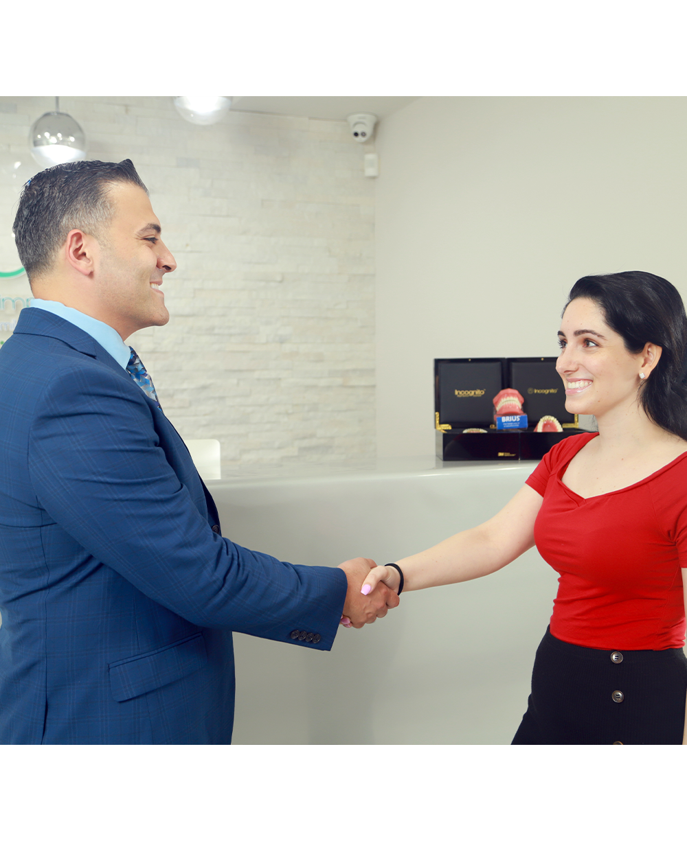 Orthodontist shaking patient's hand