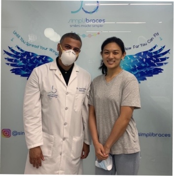 Queens orthodontist and teen girl patient smiling in orthodontic office