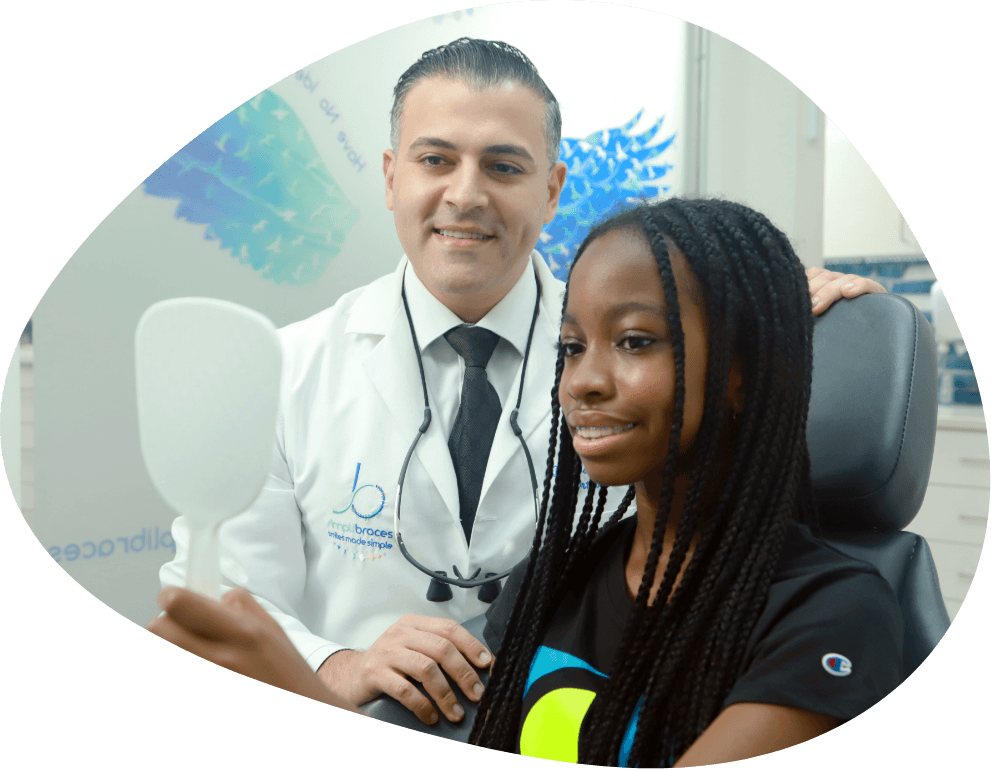 Orthodontist in Queens with a young girl in treatment chair