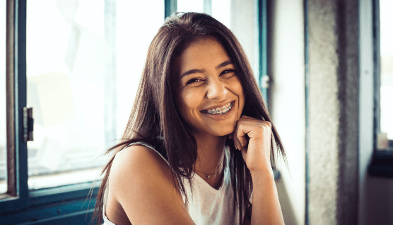 Smiling teen with traditional braces