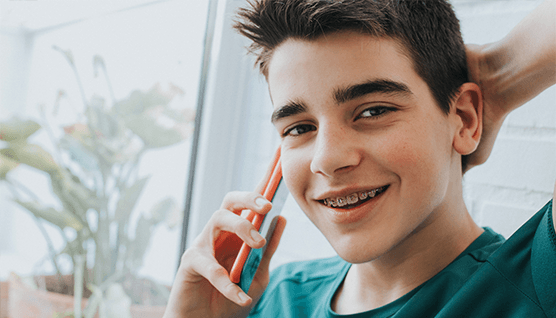 Teen with braces talking on cellphone