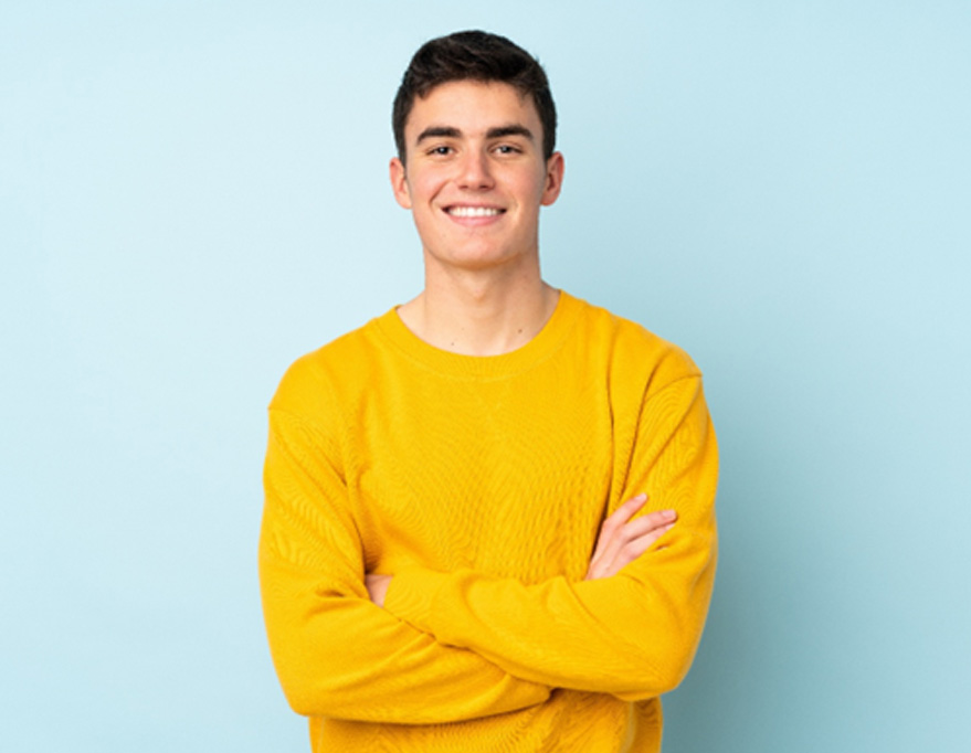 Smiling teen boy wearing yellow shirt