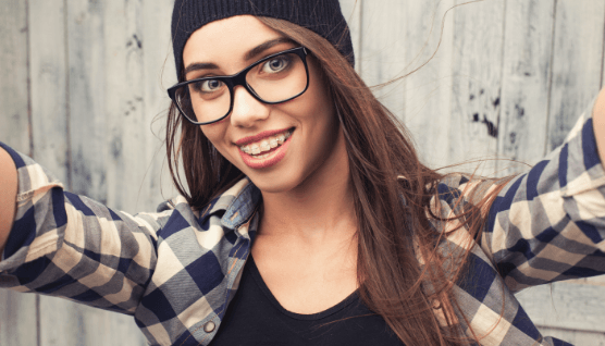 Smiling teen with clear and ceramic braces