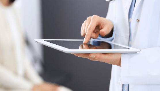 Orthodontist using tablet to review patient treatment plan