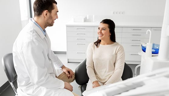 Dentist and patient talking in dental office