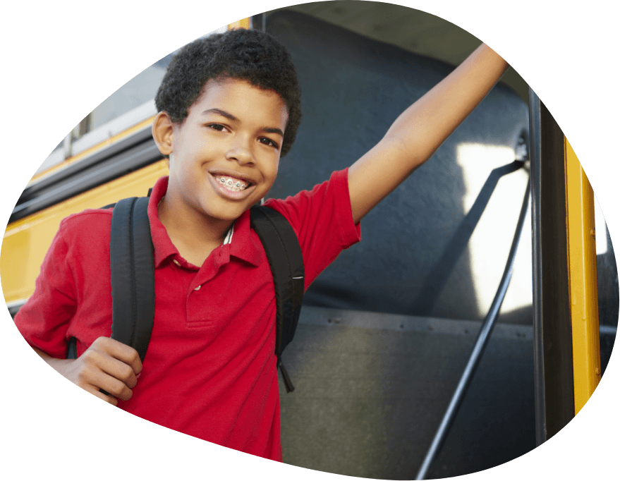 Child with braces getting on school bus