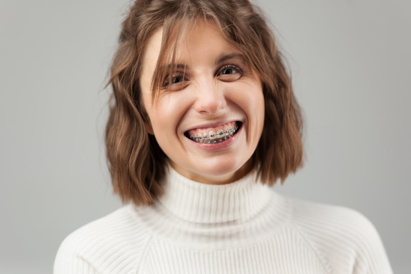 Woman with braces smiles.