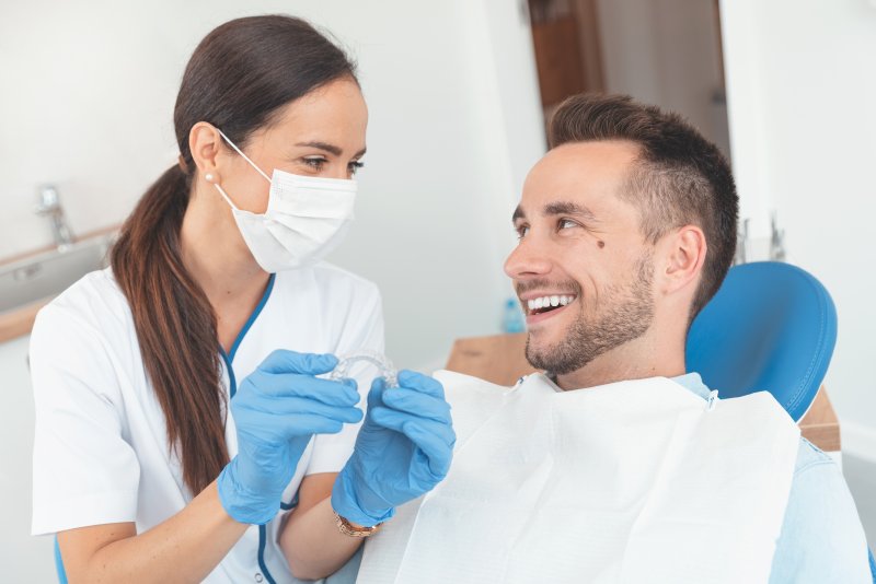 man talking to dentist about Angel Aligners