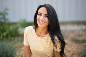 Young woman in yellow striped shirt smiling